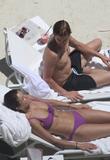 Helena Christensen in purple bikini and topless at the pool in Miami